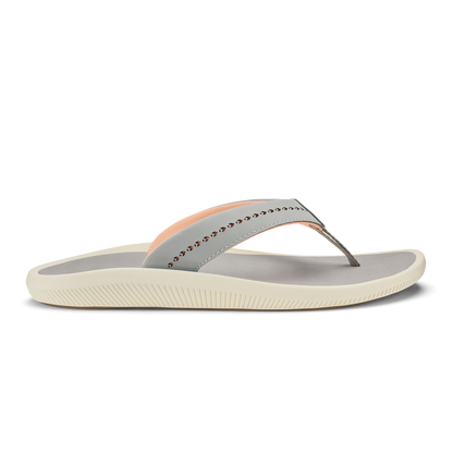 Ash-colored thong sandal with peach accent stripe, studded strap detail, and cream-colored ridged sole.