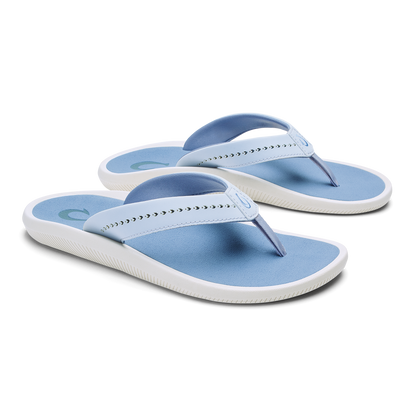 Pair of blue and white thong sandals with studded straps and cushioned soles.