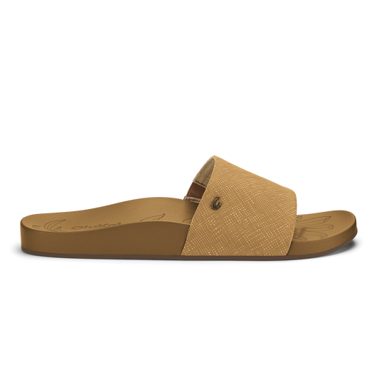 Tan slide sandal with textured crosshatch upper and solid sole featuring decorative line detailing.