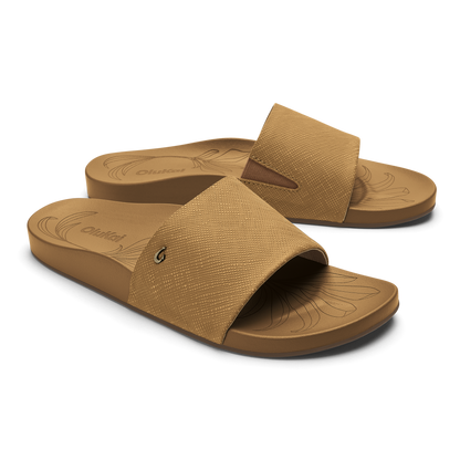 Tan slide sandals with textured crosshatch fabric upper and molded sole, shown in pair from front and back angles.