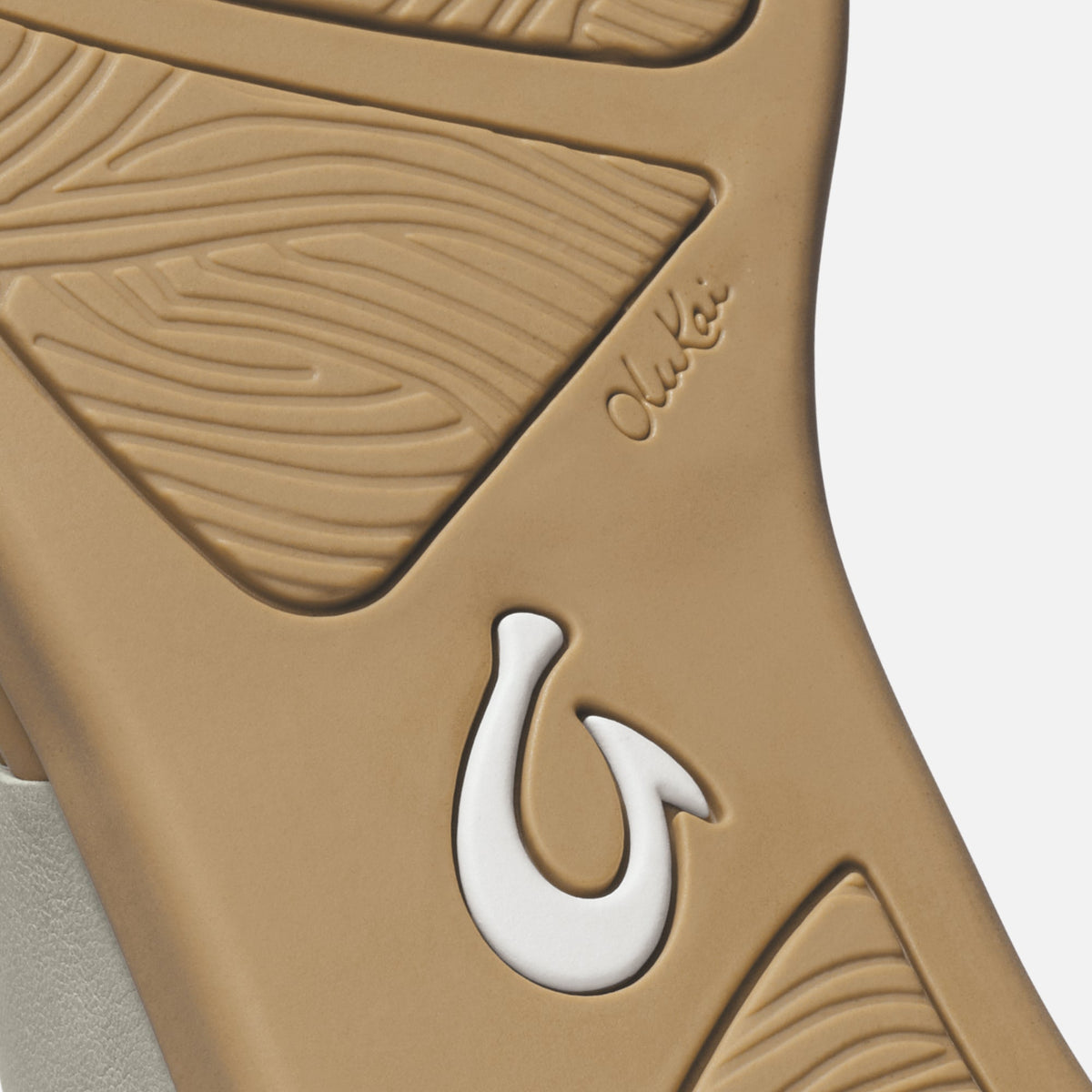 Warm sand-colored tapa with embossed leaf patterns and white fish hook accent detail.