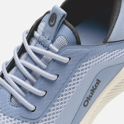 Light blue and dark gray lace-up athletic shoe with white laces and patterned side panel.