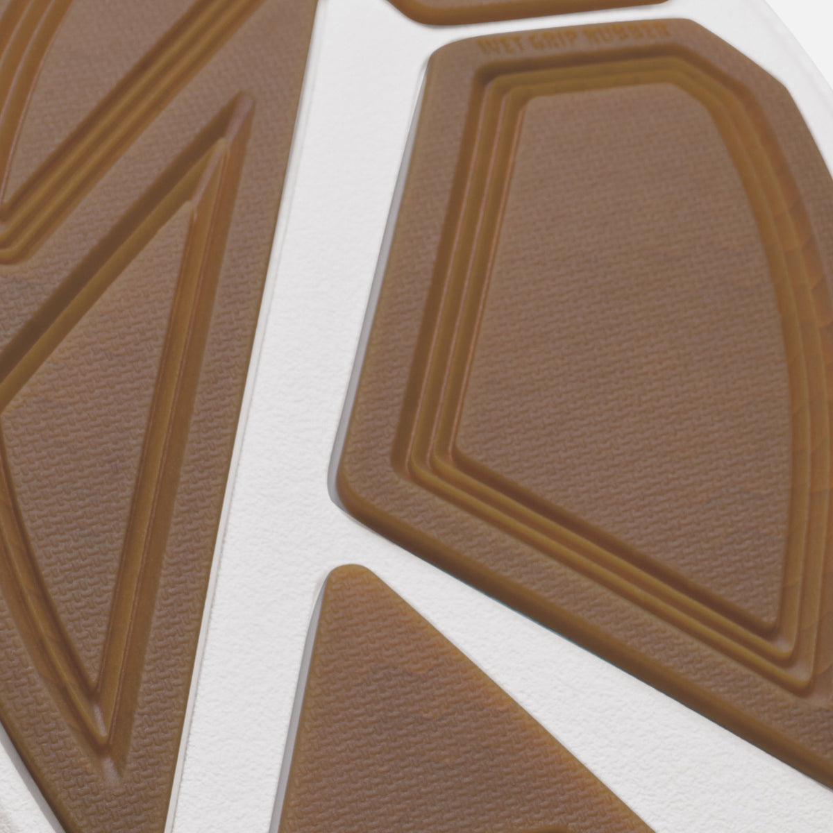 Tan rubber sole with geometric pattern and white midsole stripe detail.