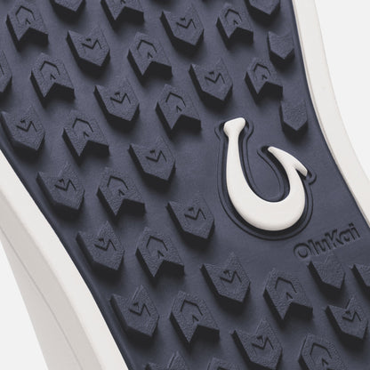 Trench blue sole with bright white hook detail and textured tread pattern.