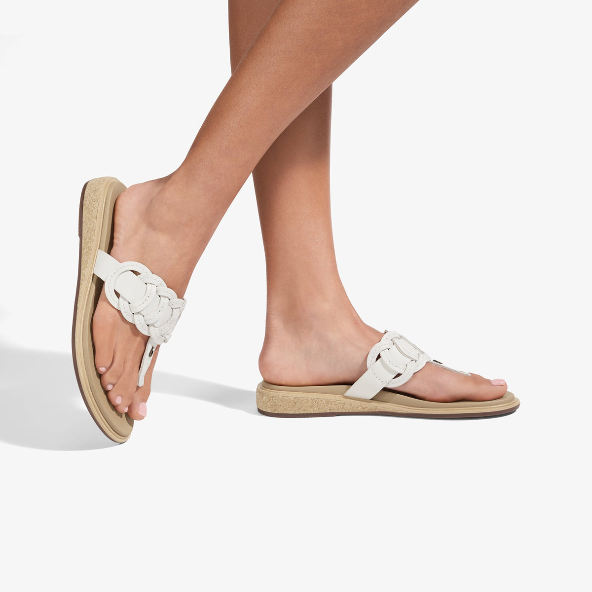 White braided strap sandals with warm sand-colored cork sole and footbed.