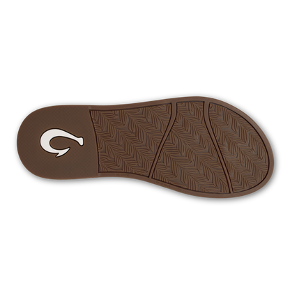 Brown sole of sandal with textured pattern and white curved logo on heel.