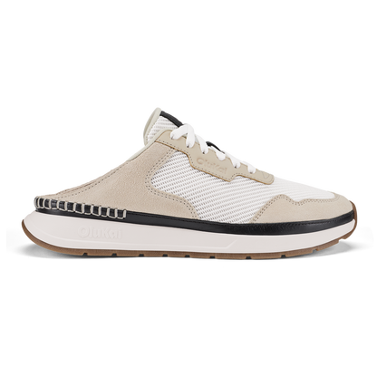 Mule-style sneaker in bright white and ecru with black trim, mesh and suede upper, and tan rubber sole.