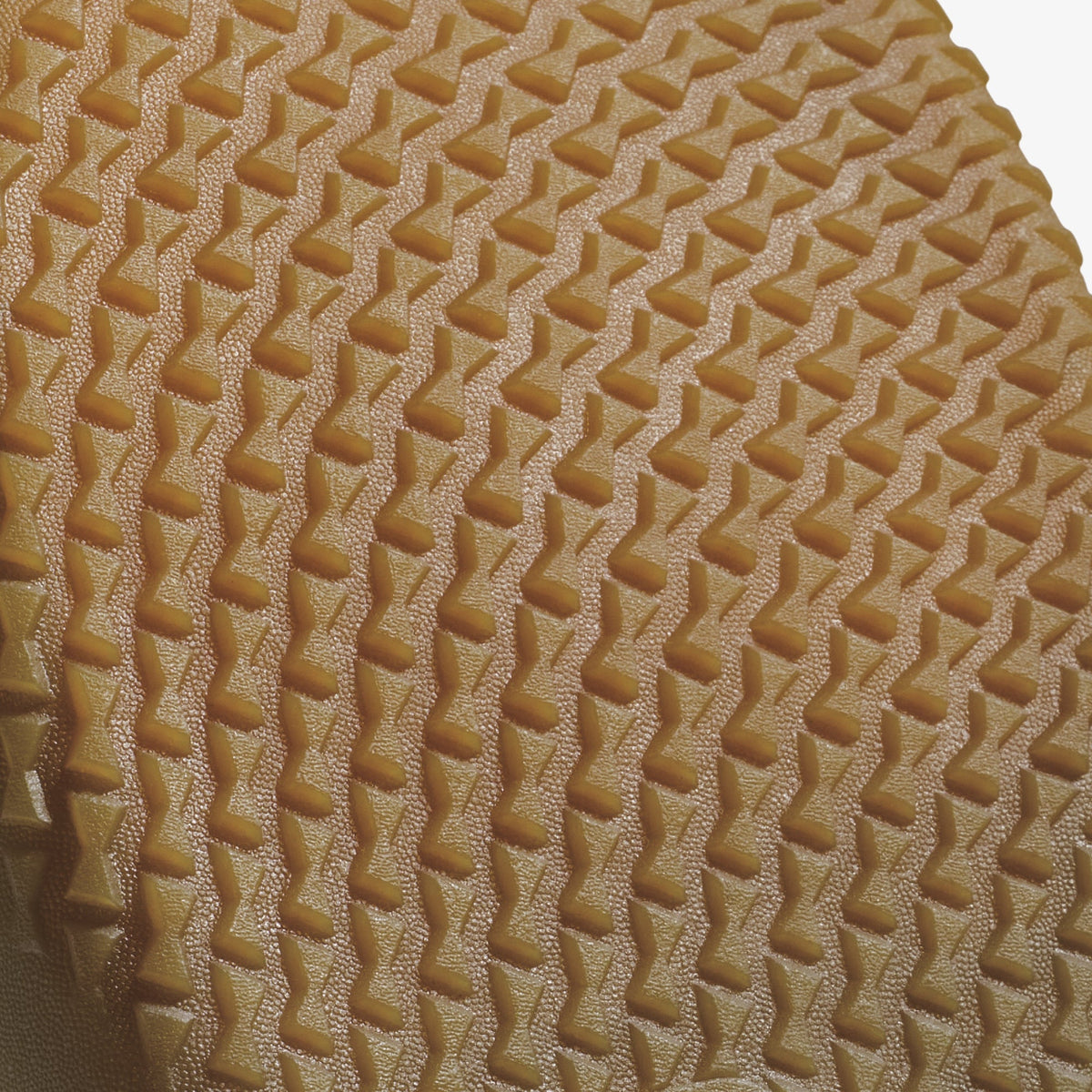 Walnut-colored quilted textile with diagonal geometric pattern and raised diamond stitching.