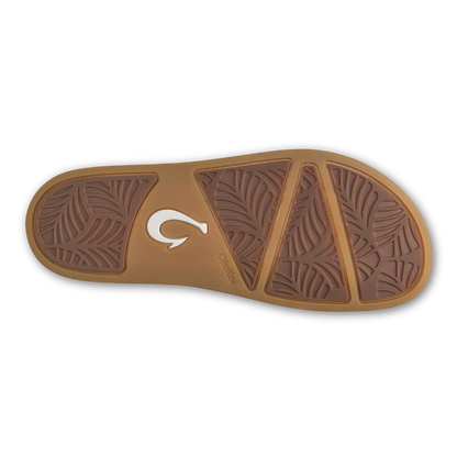 Tan and brown sandal sole with leaf-pattern tread design and white logo detail.