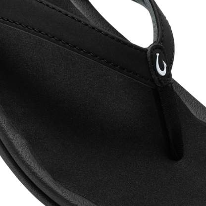 Black neoprene shoulder bag with curved body, dual handles, and white logo detail on strap.