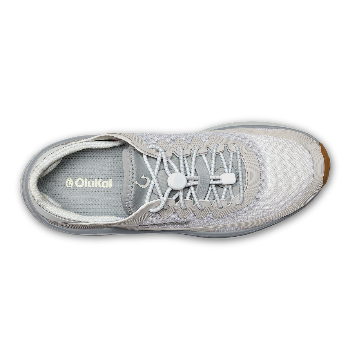 OluKai Ahi athletic shoe in bright white and grey with brown heel accent, shown from top view.