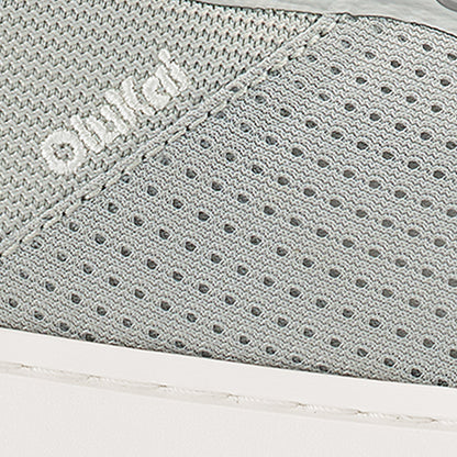 Cloud grey textured fabric with geometric patterns and perforated details.