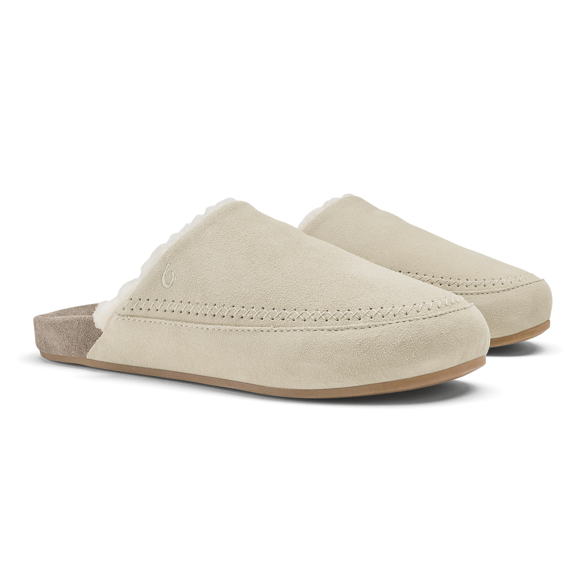 Pair of cream and taupe suede slip-on mules with stitched seams and cushioned soles.