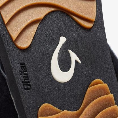 Black lava rock hook with white fish-shaped design and tan wave accents on surface.