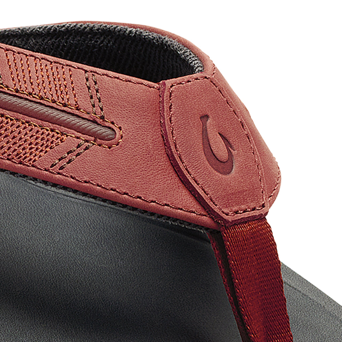 Terracotta and black leather shoe collar detail with mesh panel and brand logo embossment.