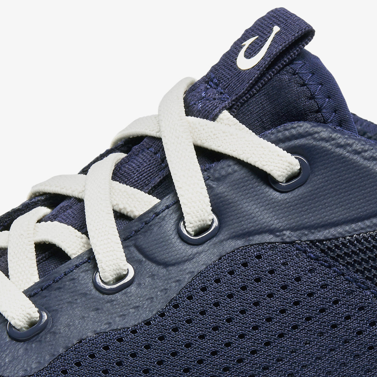 Navy blue sneaker with white laces, perforated mesh panel, and heel pull tab.